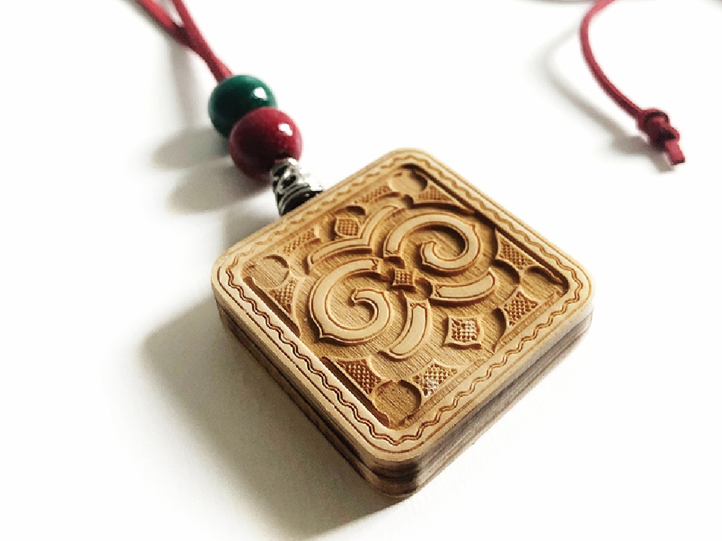 A pendant with Ainu pattern